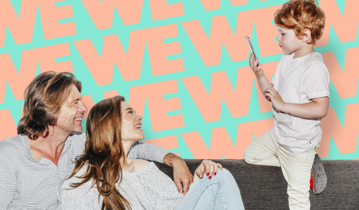 Mother Father son on sofa with child using internet and playing with parents showing high speed internet being used in a family situation